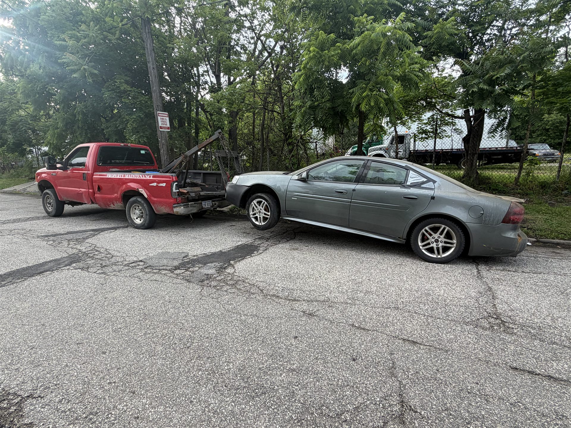 Tow truck removing a gray sedan in Northeast Ohio